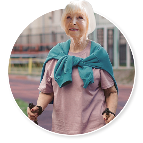 Senior woman walking outdoors with fitness poles