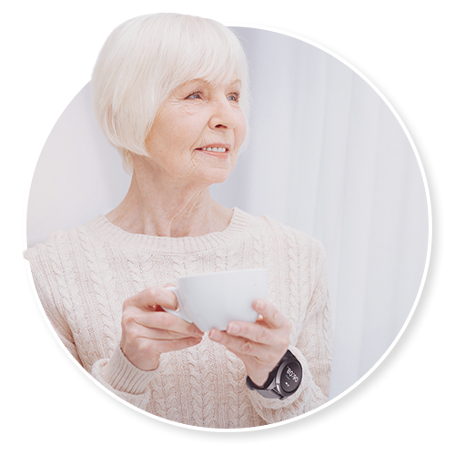 Senior woman holding a cup while wearing a watch
